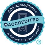 "A COA Accreditation badge with a ribbon across it labeled 'Accredited.' The text around the badge reads 'COA Accreditation - A Service of Social Current.' The badge is set against a solid blue background."